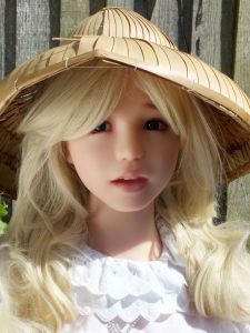 Meotzi life size doll in a wooden hat